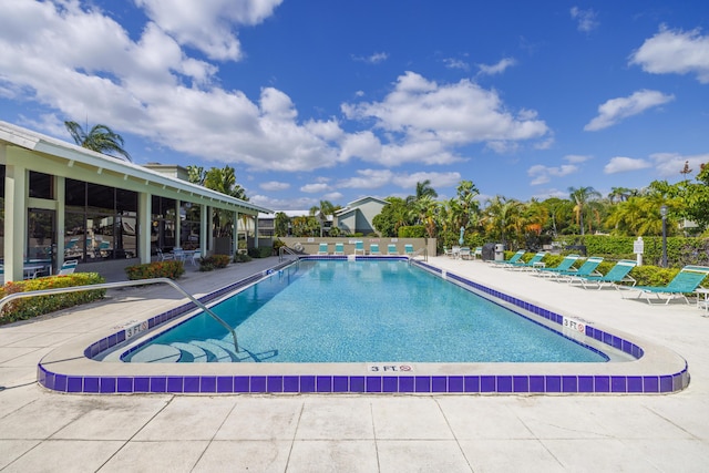 pool featuring a patio and fence