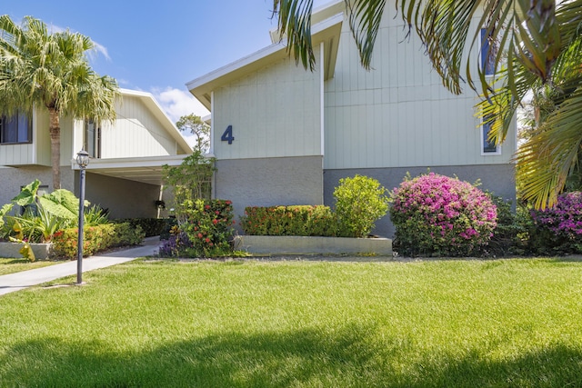 view of side of property with a yard