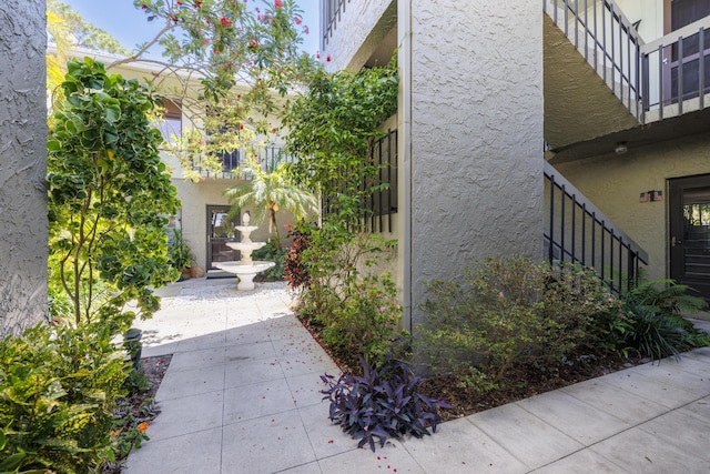 view of side of home with stucco siding