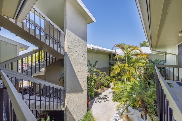 view of property exterior featuring stucco siding and stairway