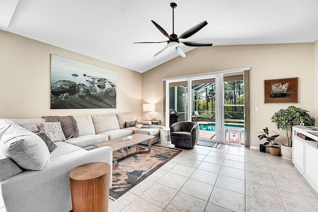 living area featuring ceiling fan, lofted ceiling, and light tile patterned floors