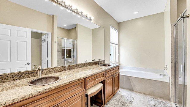 full bath featuring a shower stall, a bath, and double vanity