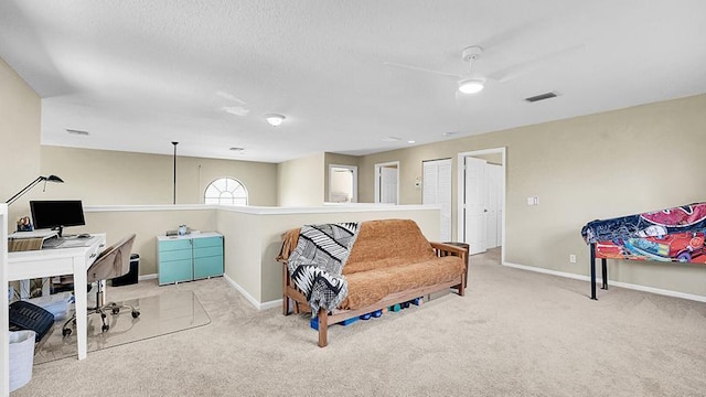 home office with carpet flooring, ceiling fan, and baseboards