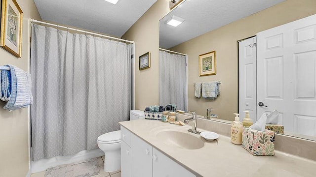 bathroom featuring tile patterned floors, toilet, and vanity