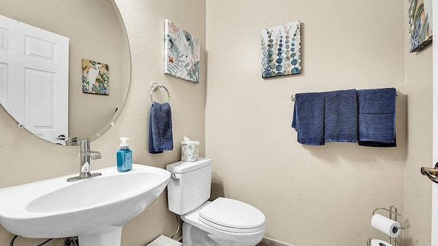 bathroom with toilet and a sink