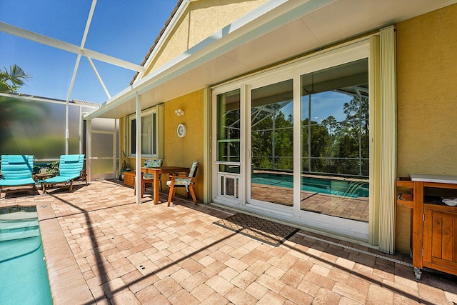 view of patio / terrace with an outdoor pool and a lanai
