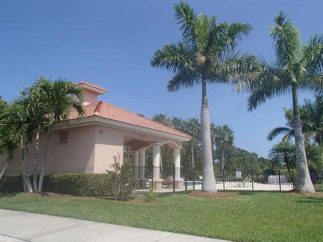 view of property exterior featuring a tile roof and stucco siding