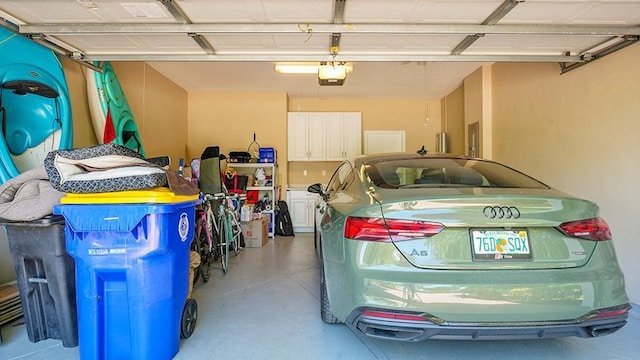 garage with a garage door opener and electric panel