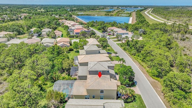 aerial view of residential area featuring a large body of water