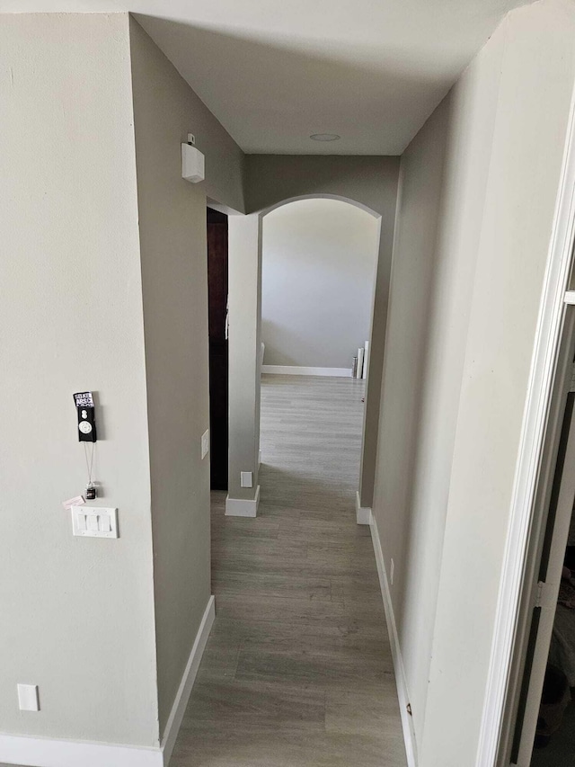 7861 Manor Forest Ln, Boynton Beach, FL 33436 - corridor with arched walkways, wood finished floors, and baseboards