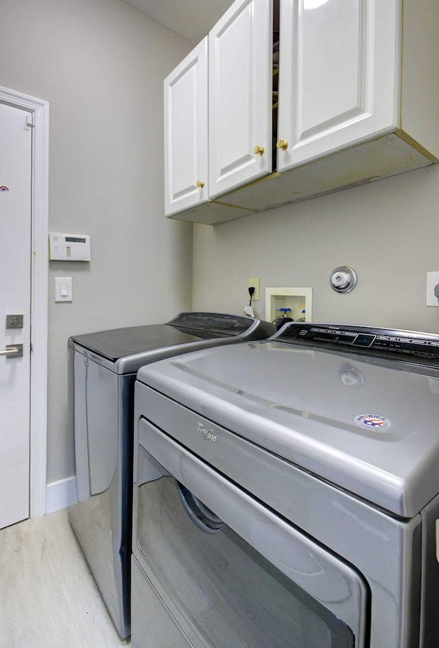 7861 Manor Forest Ln, Boynton Beach, FL 33436 - washroom with washer and dryer, cabinet space, wood finished floors, and baseboards