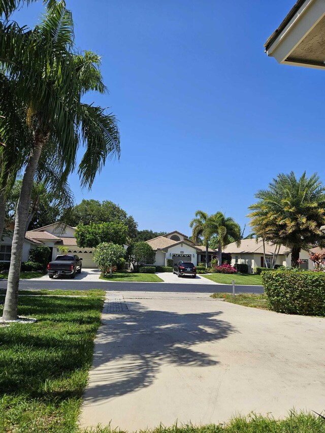 7861 Manor Forest Ln, Boynton Beach, FL 33436 - view of concrete driveway with a residential view