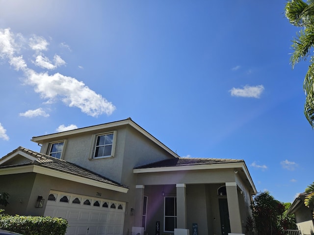 7861 Manor Forest Ln, Boynton Beach, FL 33436 - view of front facade featuring stucco siding and a garage