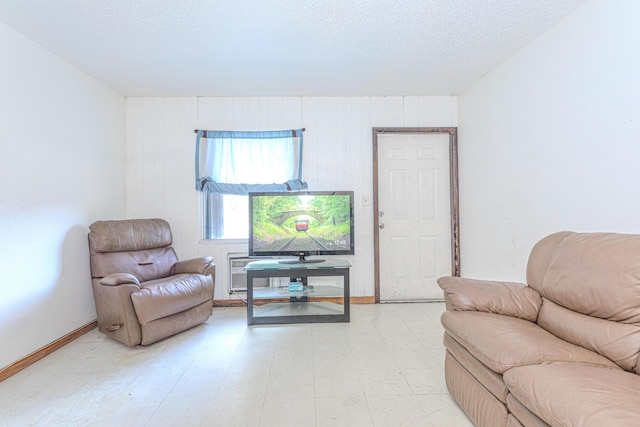 1043 NE 20th St, Belle Glade, FL 33430 - living room featuring wooden walls, a textured ceiling, and light floors
