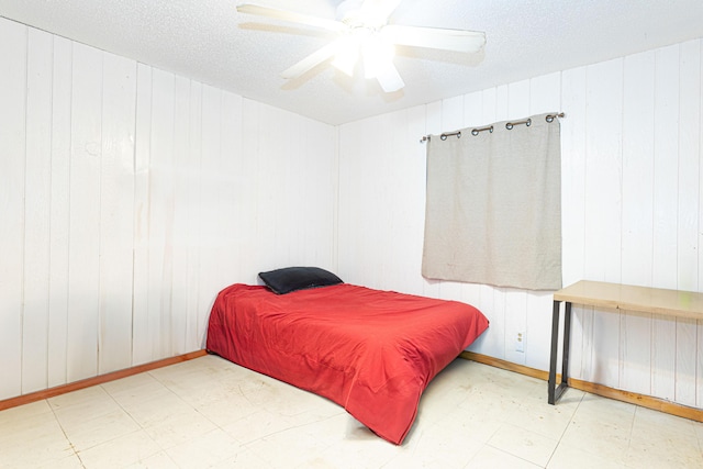 1043 NE 20th St, Belle Glade, FL 33430 - bedroom featuring tile patterned floors, baseboards, a ceiling fan, and wood walls