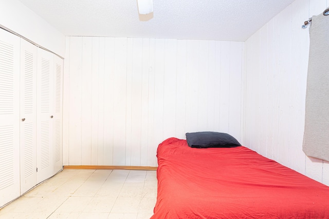 1043 NE 20th St, Belle Glade, FL 33430 - bedroom featuring a ceiling fan, tile patterned floors, and wood walls
