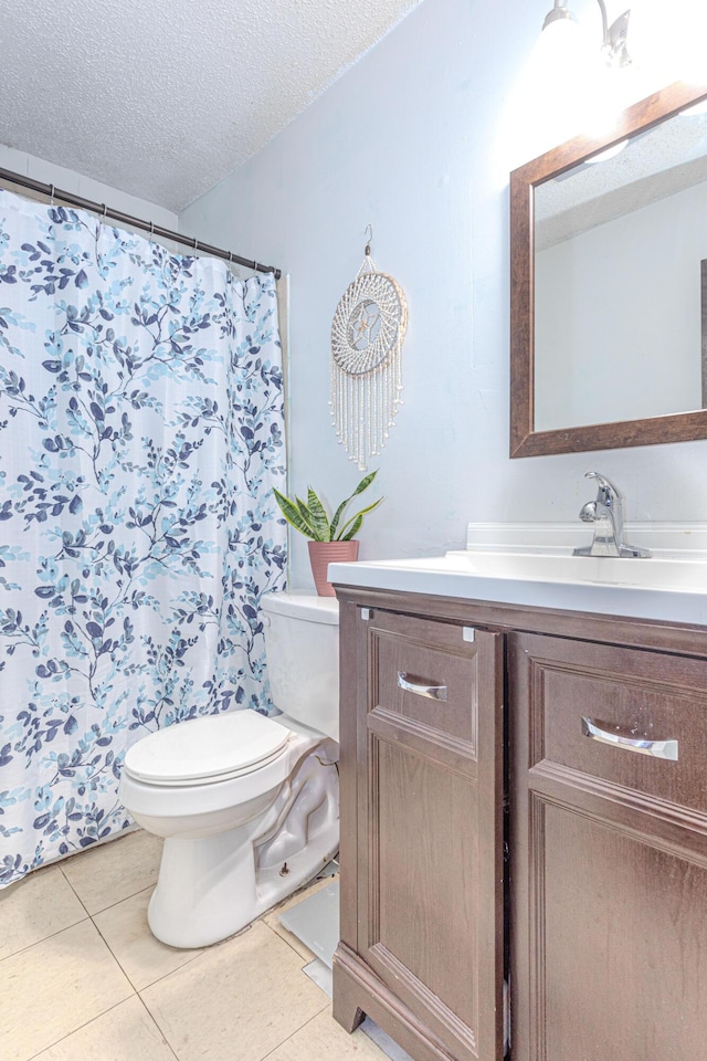 1043 NE 20th St, Belle Glade, FL 33430 - bathroom featuring a textured ceiling, tile patterned flooring, curtained shower, vanity, and toilet