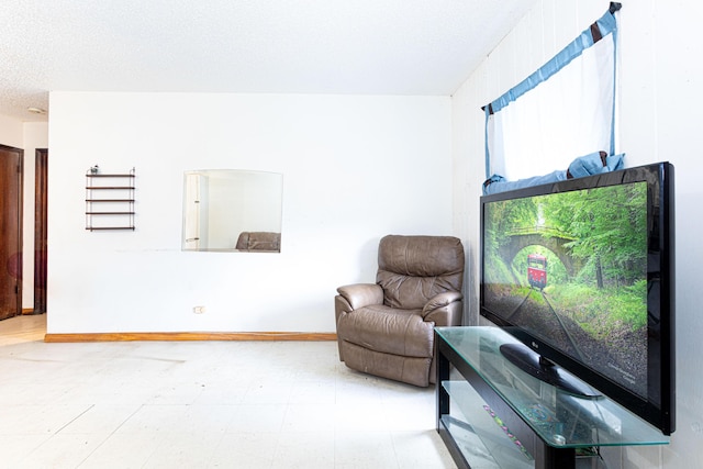 1043 NE 20th St, Belle Glade, FL 33430 - sitting room with baseboards, a textured ceiling, and tile patterned floors