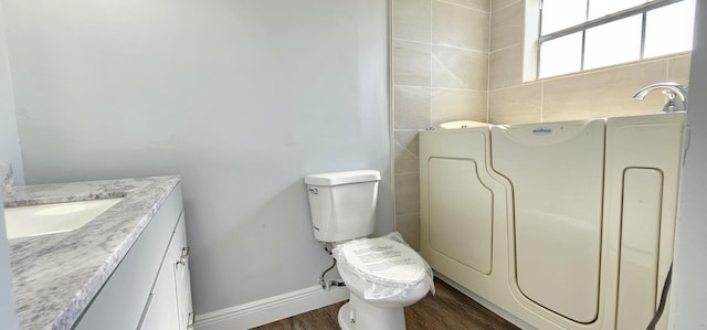 4141 NW 44th Ave Unit 217, Lauderdale Lakes, FL 33319 - bathroom with vanity, baseboards, wood finished floors, and toilet