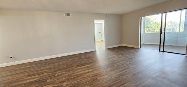 4141 NW 44th Ave Unit 217, Lauderdale Lakes, FL 33319 - interior space with baseboards, visible vents, access to exterior, and dark wood-type flooring