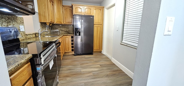 4141 NW 44th Ave Unit 217, Lauderdale Lakes, FL 33319 - kitchen with decorative backsplash, light wood-style floors, a sink, dark stone countertops, and appliances with stainless steel finishes