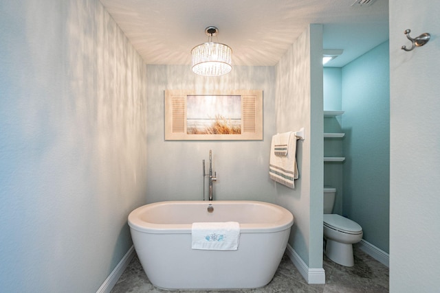 1566 SW Andalusia Rd, Port Saint Lucie, FL 34953 - bathroom featuring baseboards, tile patterned floors, a freestanding bath, and toilet