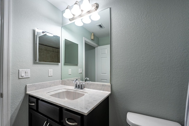 1566 SW Andalusia Rd, Port Saint Lucie, FL 34953 - bathroom featuring visible vents, vanity, a textured wall, toilet, and a chandelier