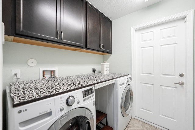 1566 SW Andalusia Rd, Port Saint Lucie, FL 34953 - clothes washing area with cabinet space, a textured ceiling, and washing machine and clothes dryer