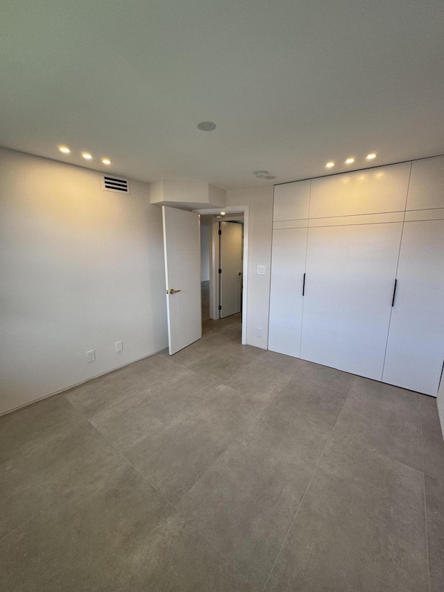 unfurnished bedroom featuring recessed lighting and visible vents