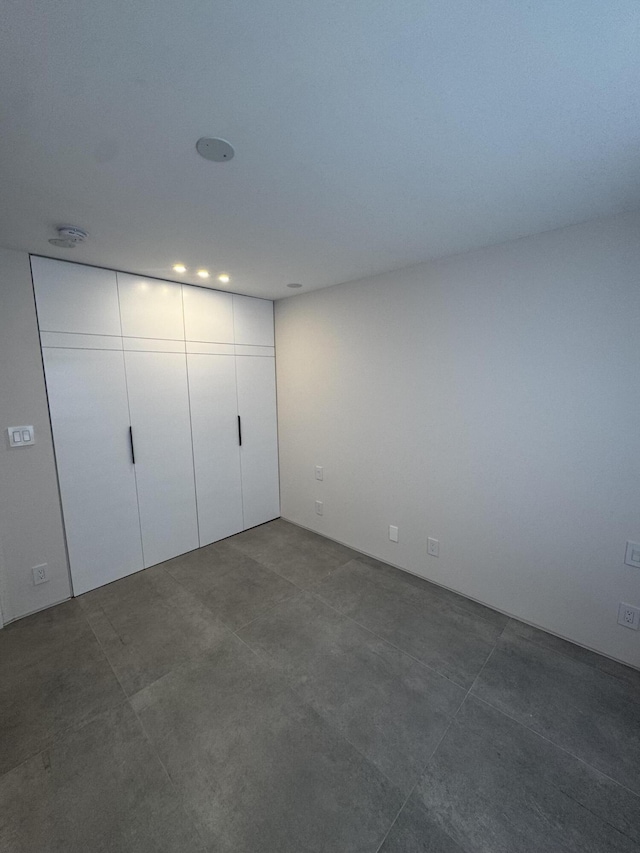 2871 N Ocean Blvd Unit R444, Boca Raton, FL 33431 - unfurnished bedroom with recessed lighting, a closet, and concrete flooring