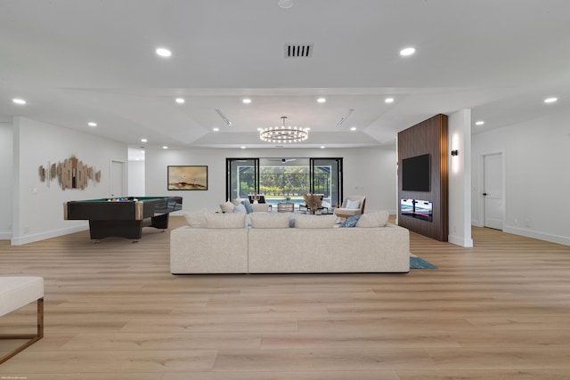 living area with light wood finished floors, a raised ceiling, billiards table, recessed lighting, and baseboards