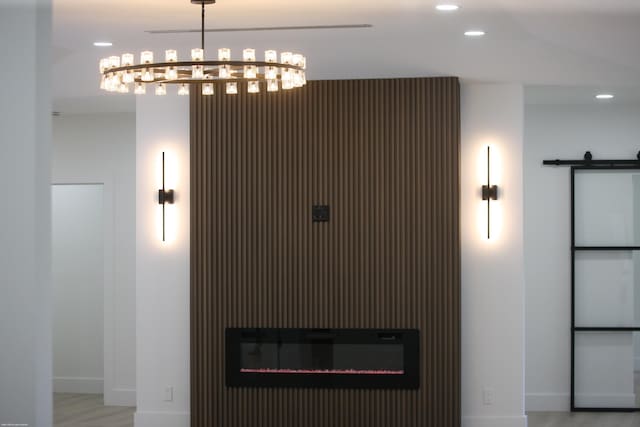 detailed view of recessed lighting, baseboards, wood finished floors, and a glass covered fireplace