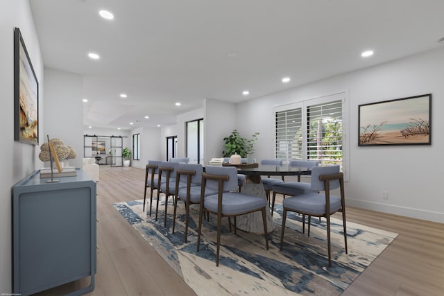 dining space featuring light wood-style floors, baseboards, and recessed lighting