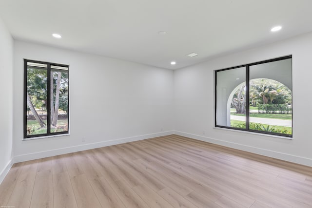 unfurnished room with recessed lighting, light wood-type flooring, and baseboards
