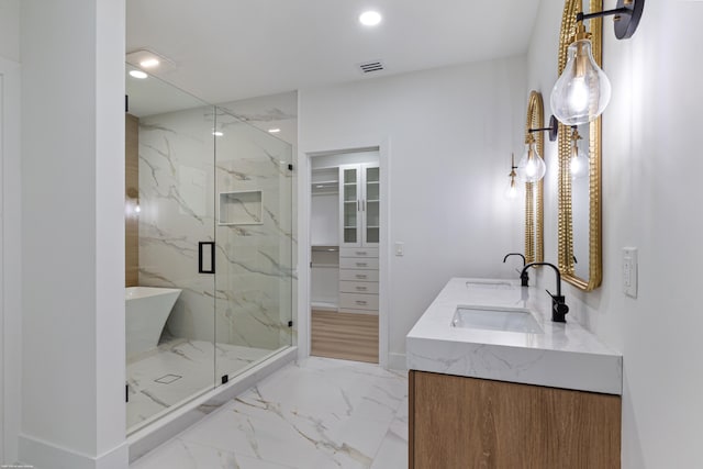 full bathroom featuring marble finish floors, a marble finish shower, recessed lighting, double vanity, and a walk in closet