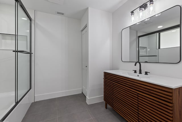 bathroom featuring baseboards, tile patterned flooring, vanity, and enclosed tub / shower combo