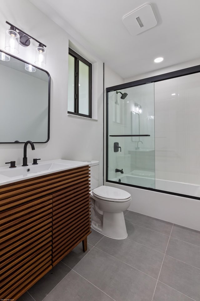 full bath with tile patterned floors, toilet, enclosed tub / shower combo, and vanity