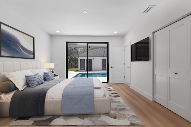 bedroom featuring access to exterior, light wood finished floors, and recessed lighting