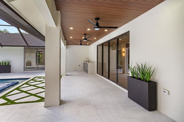 view of patio / terrace with a ceiling fan and an outdoor pool
