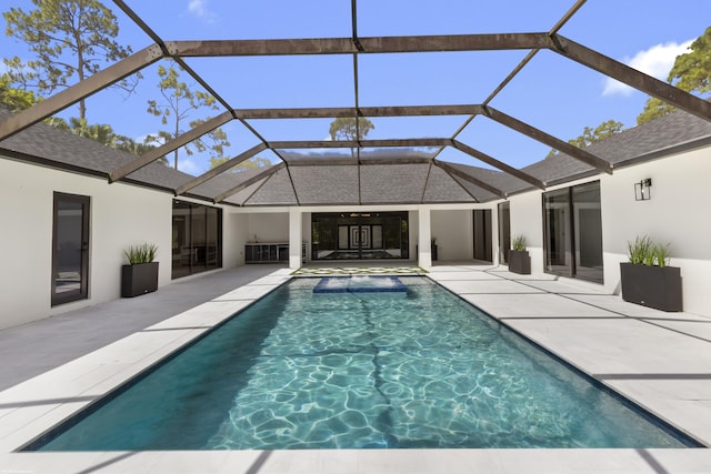 outdoor pool with a patio area and a lanai