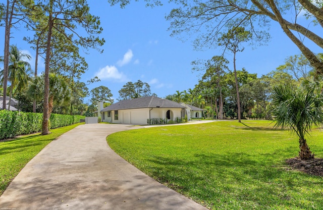 view of property exterior with driveway, a yard, and a garage