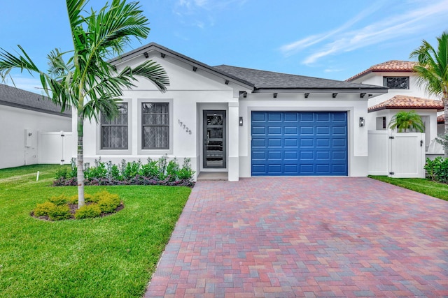 view of front of property with fence, an attached garage, stucco siding, a gate, and decorative driveway