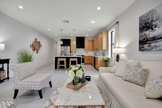living room featuring recessed lighting, baseboards, and visible vents