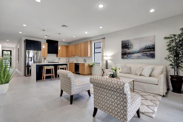 living area with concrete flooring, recessed lighting, and visible vents