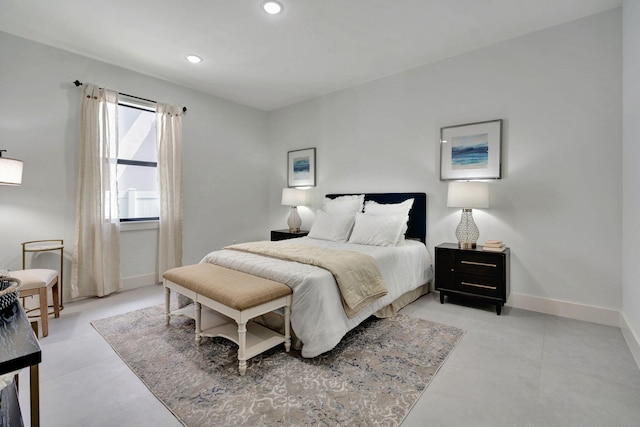 bedroom featuring recessed lighting, baseboards, and concrete flooring