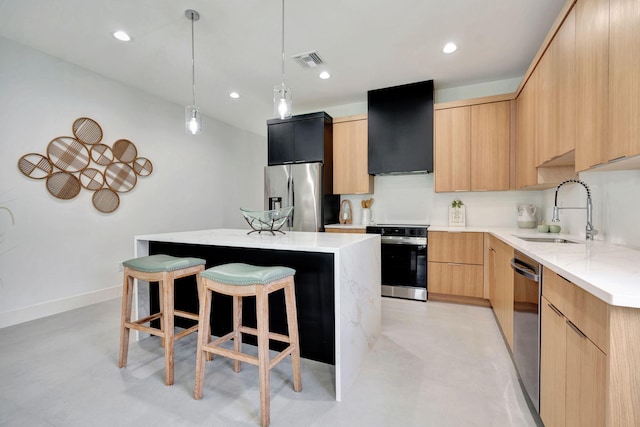 kitchen with appliances with stainless steel finishes, a sink, a kitchen island, visible vents, and modern cabinets