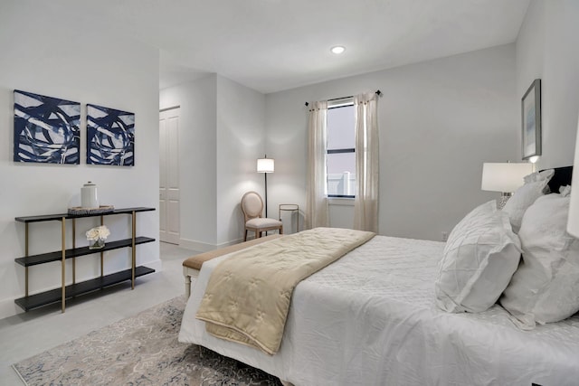 bedroom featuring recessed lighting and concrete flooring