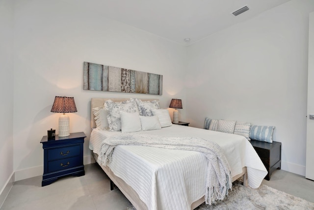 bedroom featuring baseboards and visible vents