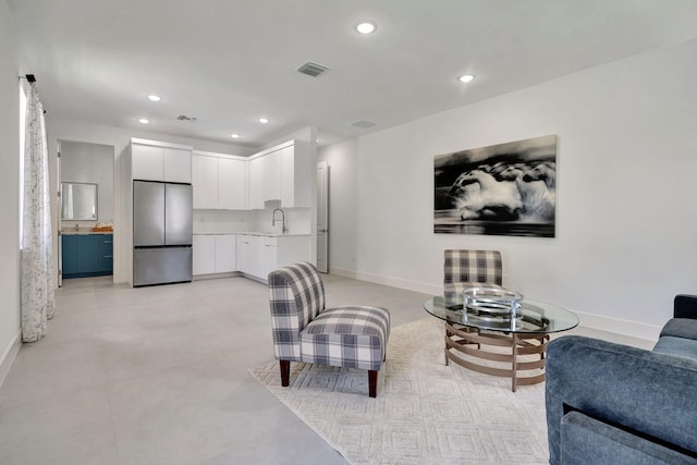 living room with baseboards, recessed lighting, and visible vents