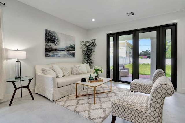living area featuring recessed lighting and visible vents